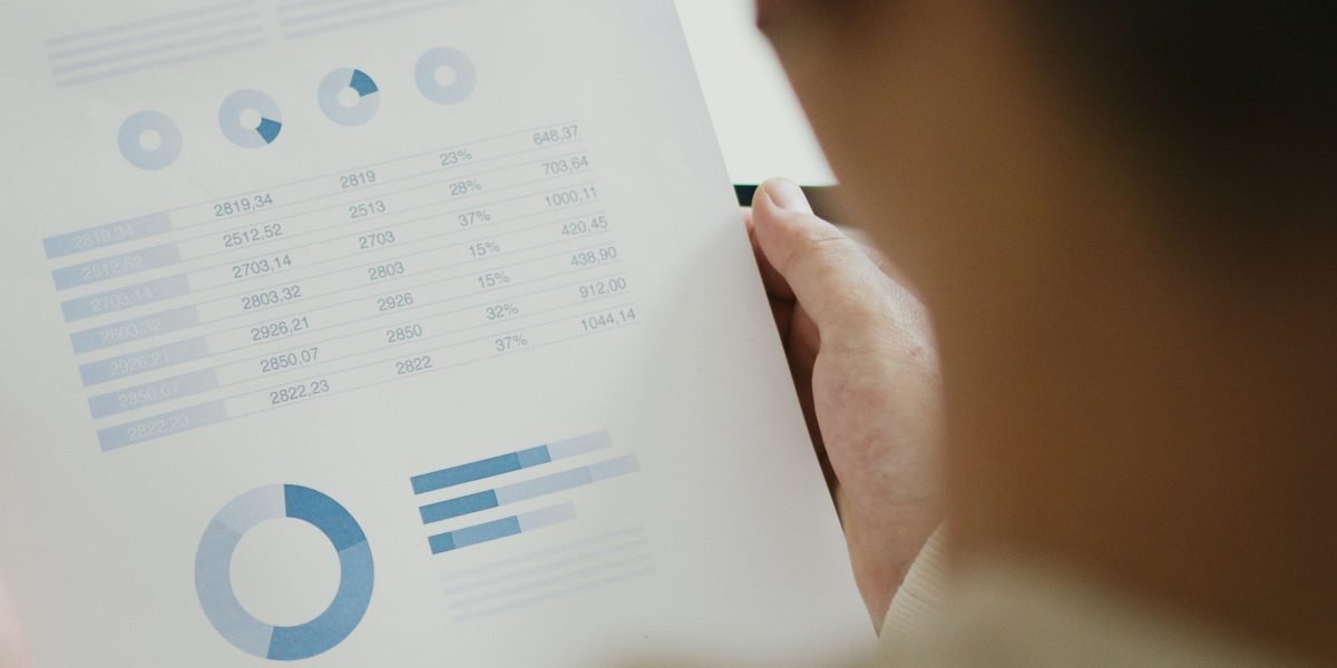 A person thoughtfully analyzing multiple data points, representing the challenge of making sense of the fast-paced AI landscape.