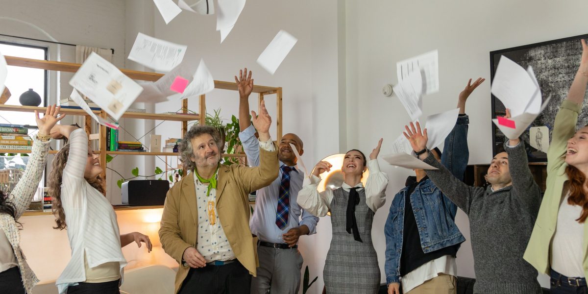 A team celebrates a successful project launch, symbolizing the culmination of robust testing, packaging, and deployment efforts.