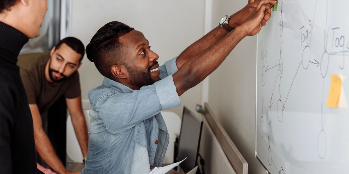 A team collaborates on a complex project, symbolizing the challenge of integrating diverse AI tools within a large enterprise.