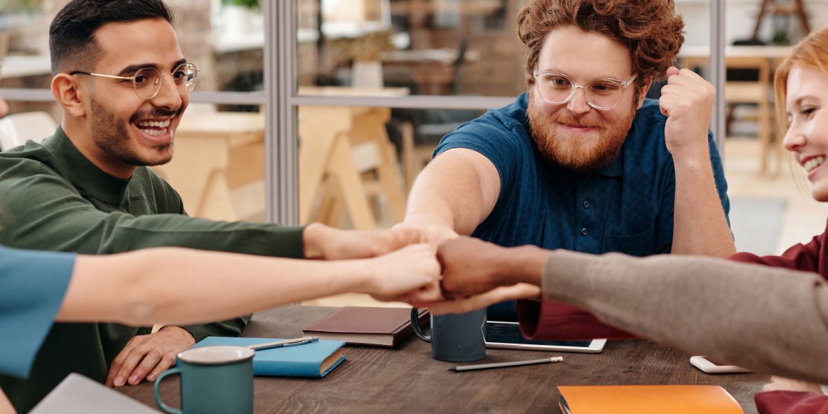 Professionals collaborating to connect different systems, representing the integration patterns and connectors of an AI gateway.