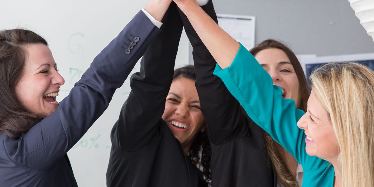 A small team celebrating an achievement, symbolizing how AI tools empower smaller legal teams.