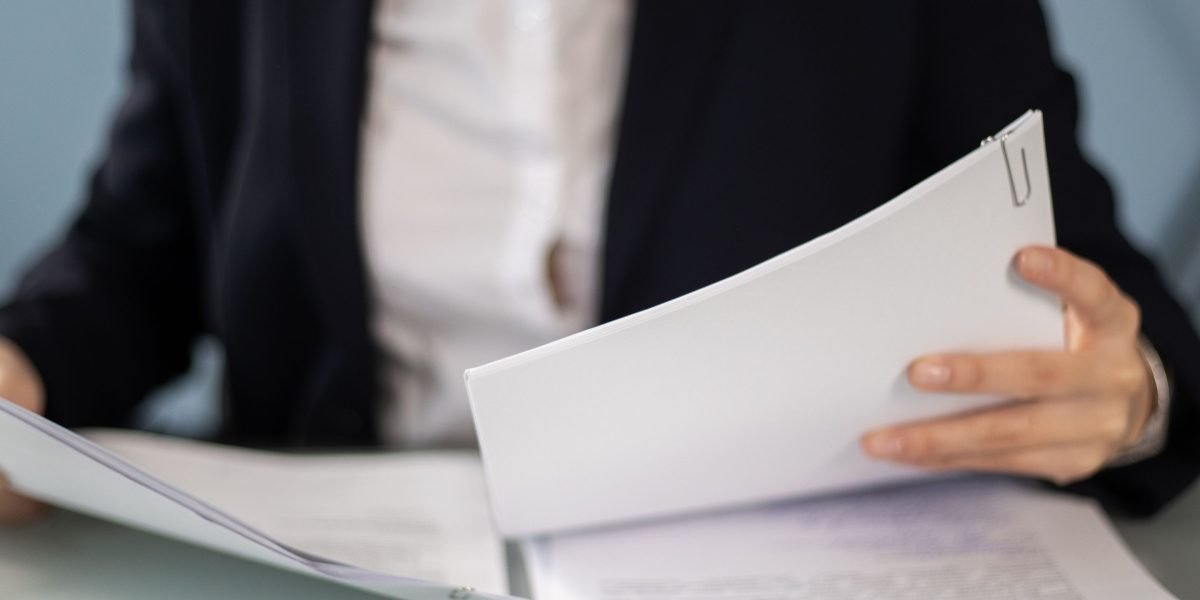 A professional meticulously reviewing data for quality and compliance to prevent errors.