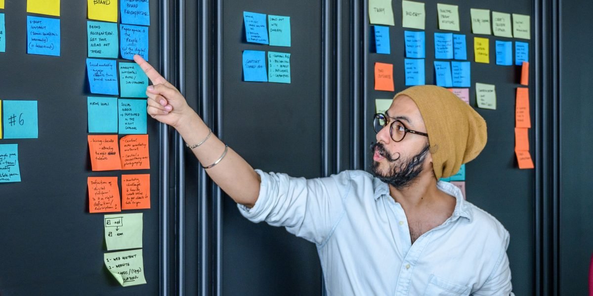A diverse team collaborating around a whiteboard, sketching ideas and discussing concepts, symbolizing the innovative spirit behind Lightchain AI's decentralized approach.