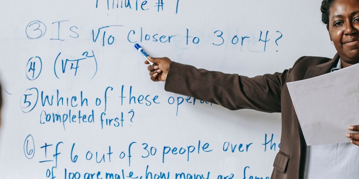A person explaining a complex concept to a group, symbolizing the clarity needed in understanding Python operators.