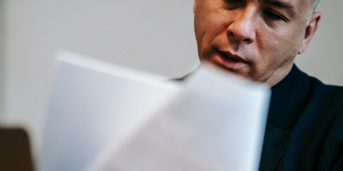 A professional diligently reviewing documents to ensure high quality and maintainability.