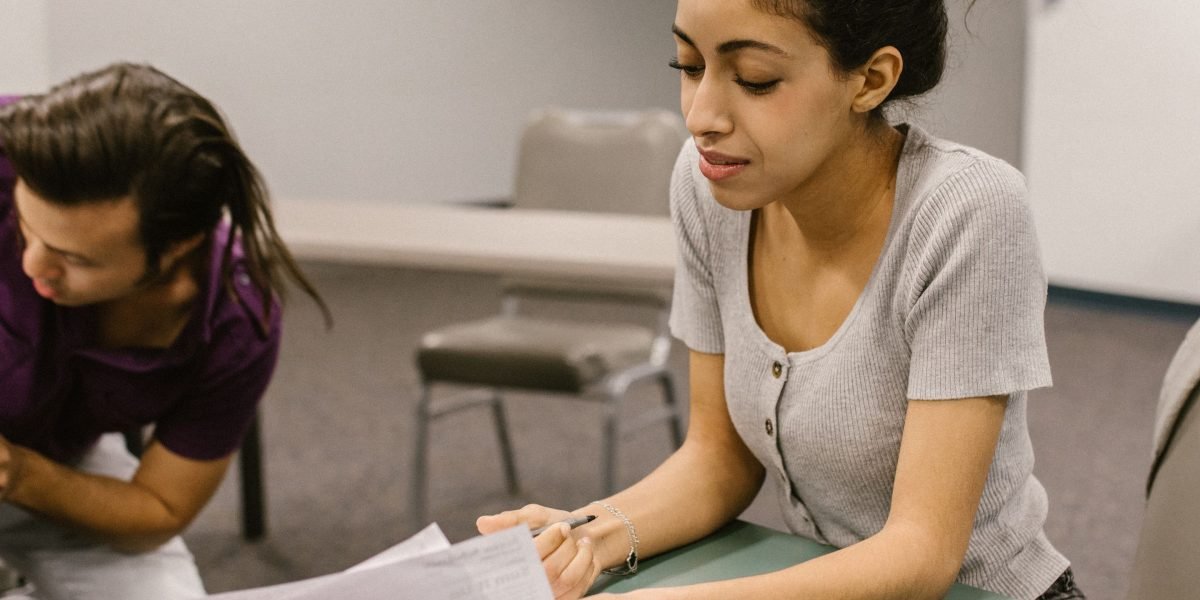 A dedicated educator provides one-on-one support to a student in a vibrant classroom setting.