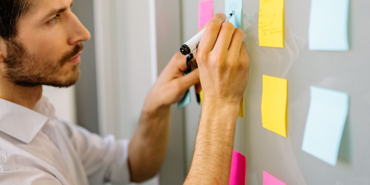 A person diligently working through a problem, using a notebook or diagram to find a solution.
