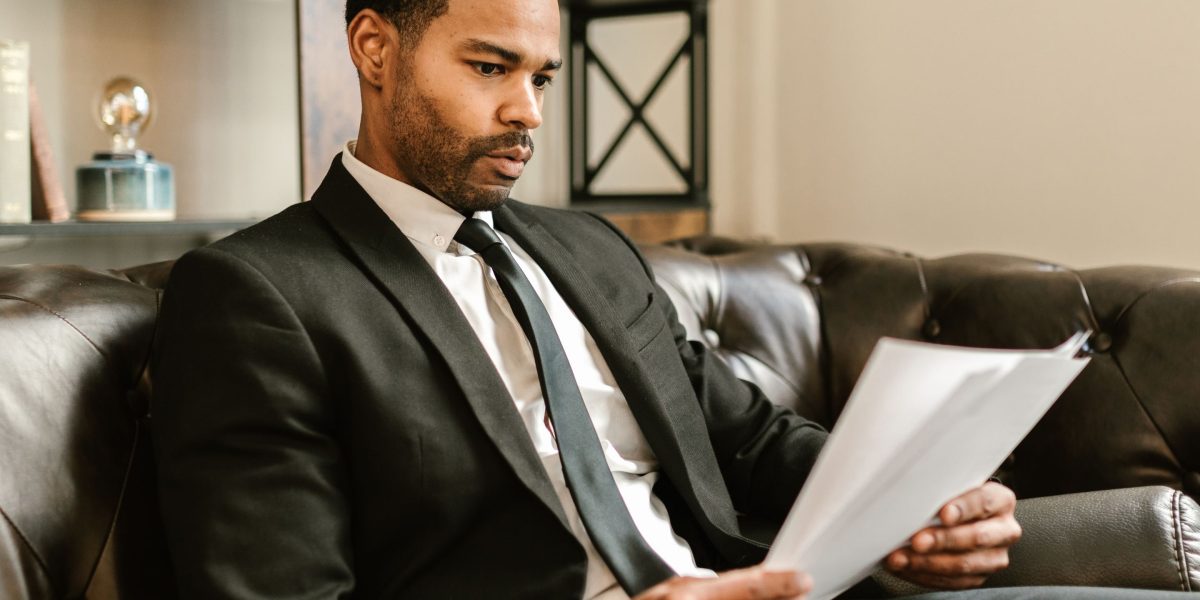A person carefully examining documents, illustrating the critical process of assessing data quality and provenance.