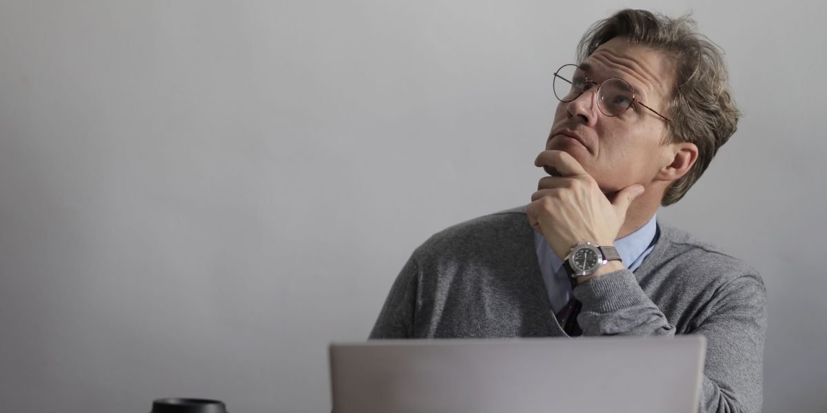 A professional engrossed in problem-solving, indicative of analyzing complex data or systems.