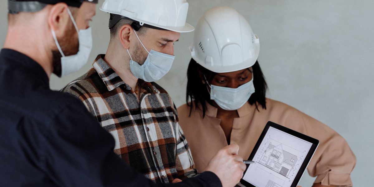 A team carefully reviewing safety protocols and checklists, crucial for designing robust and reliable AI-to-control systems.