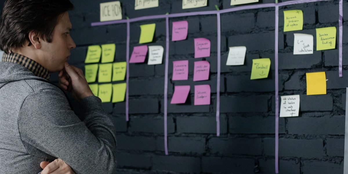 A professional analyzing data or a workflow with a focused expression, representing efficient problem-solving.
