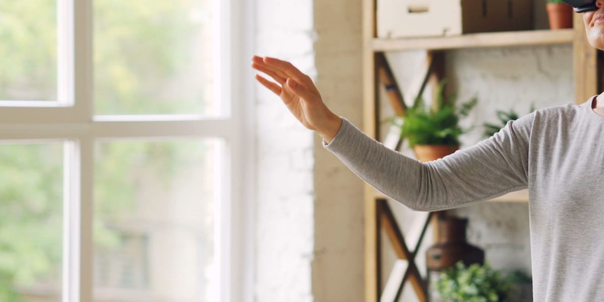 A person having a natural and intuitive interaction with a technological device, demonstrating positive user experience.