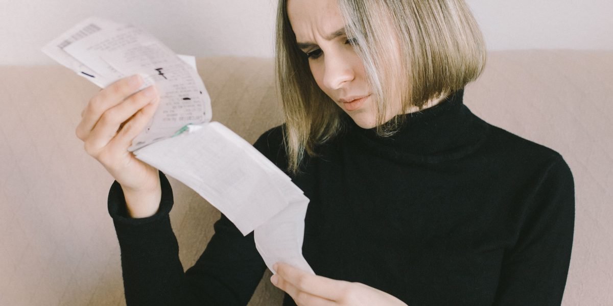 A person looking at a document with a concerned expression, illustrating the impact of poor data quality.